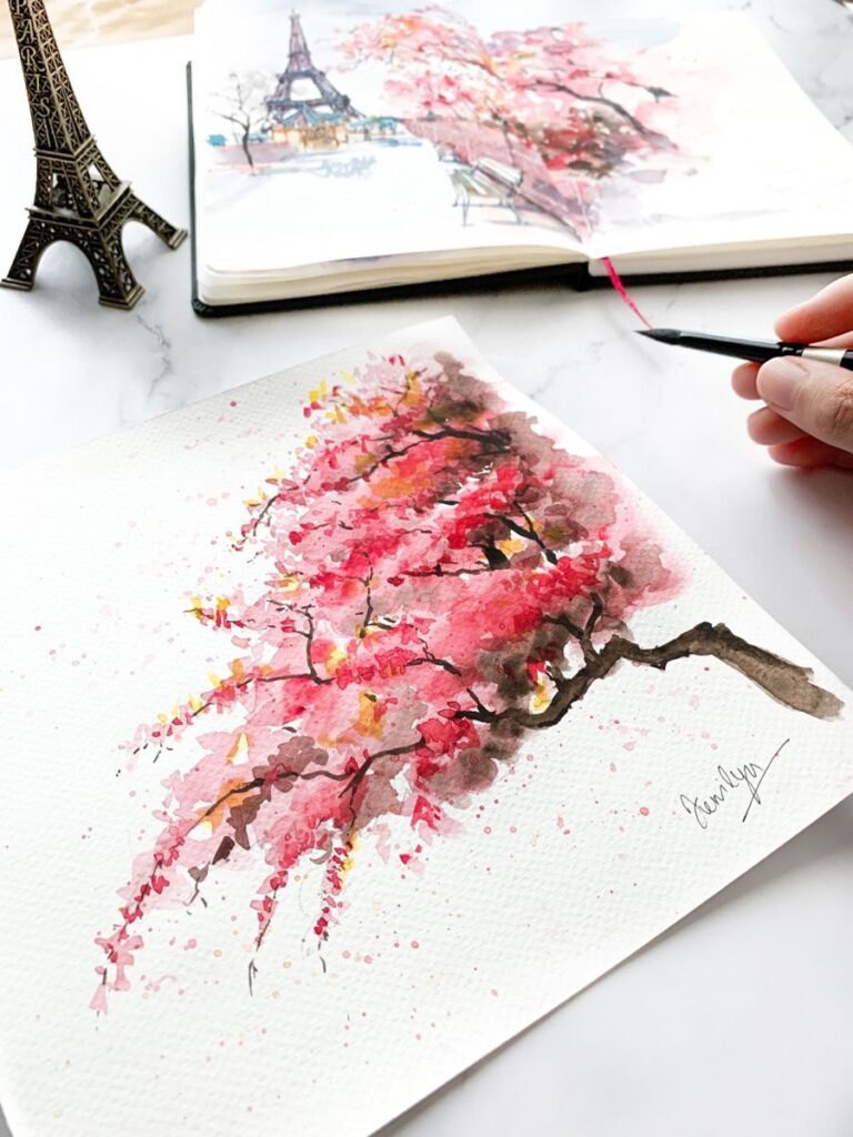 a person is painting a picture of a tree