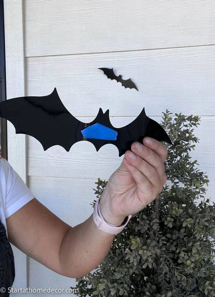 a person holding a paper bat
