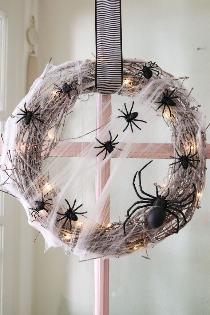 a wreath with spiders and lights