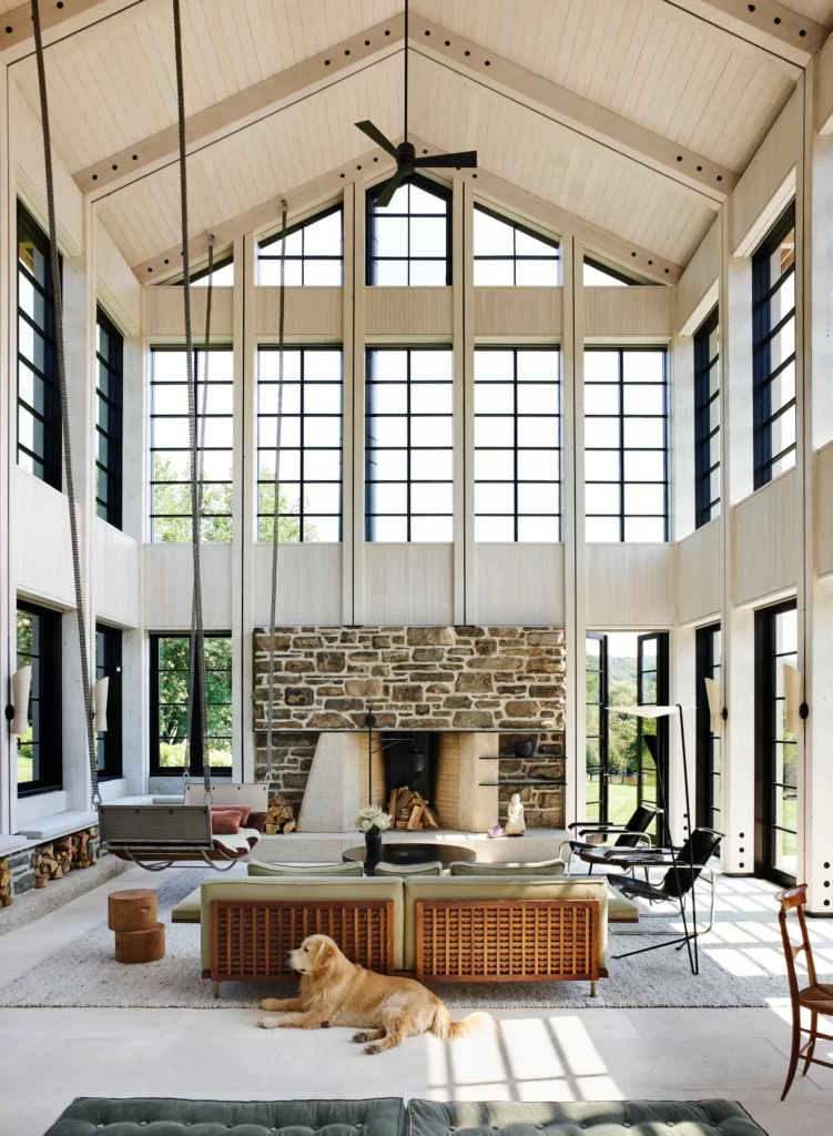 a large room with a fireplace and a large stone fireplace
