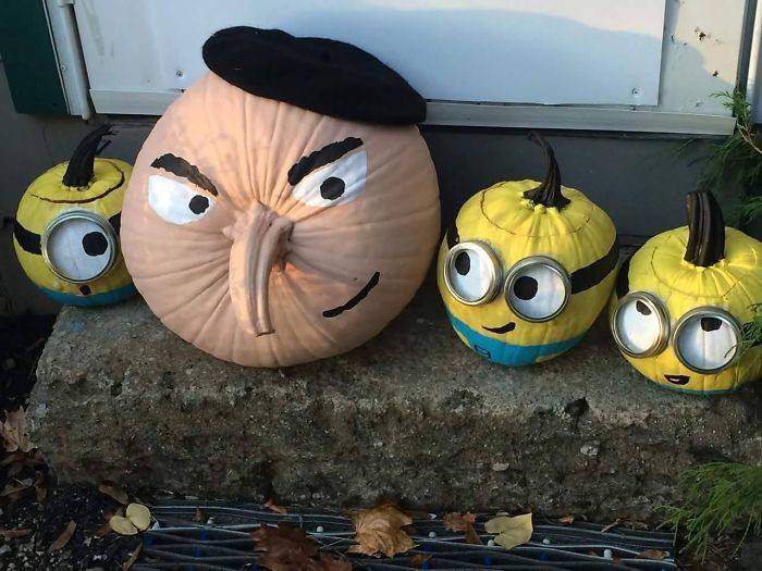a group of pumpkins with faces painted on like a minions