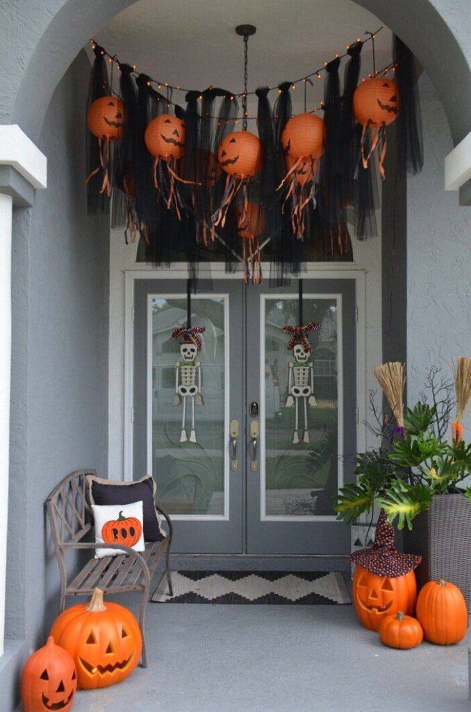 a door with pumpkins and decorations