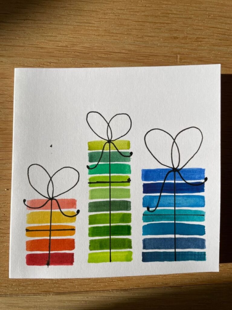 Three watercolor gift boxes on a piece of paper.
