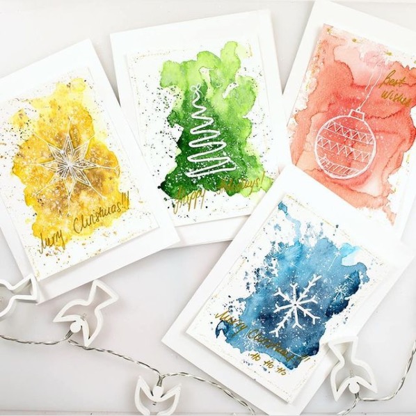 Four watercolor christmas cards with snowflakes and ornaments.