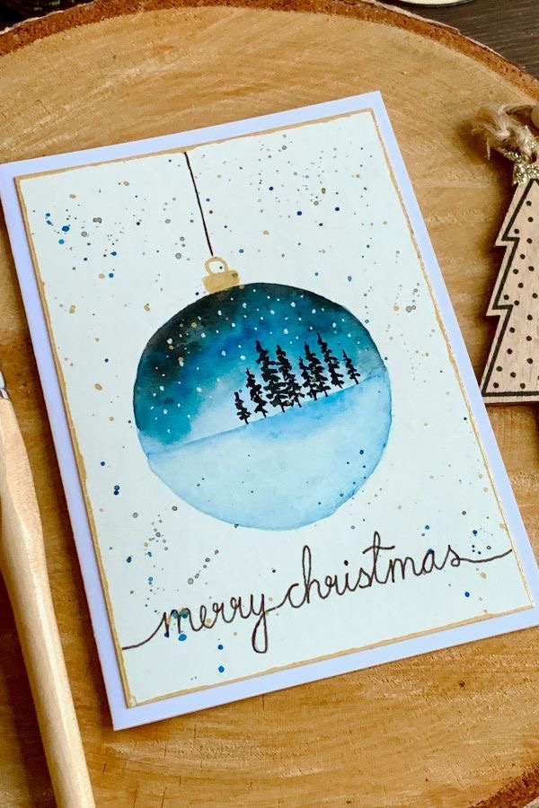 Merry christmas card with snowballs and trees on a wooden table.