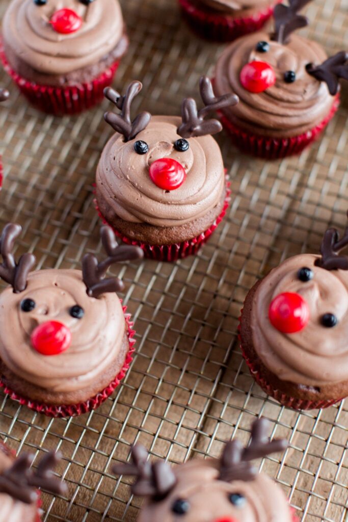 Chocolate reindeer cupcakes on a cooling rack.
