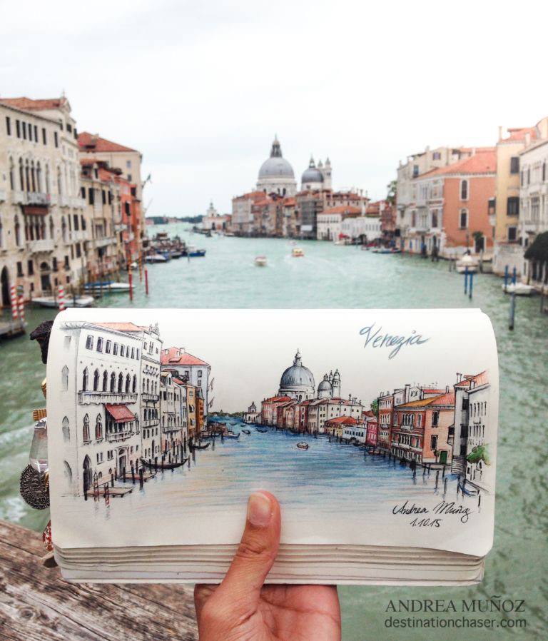 A person holding up a book with a drawing of venice.