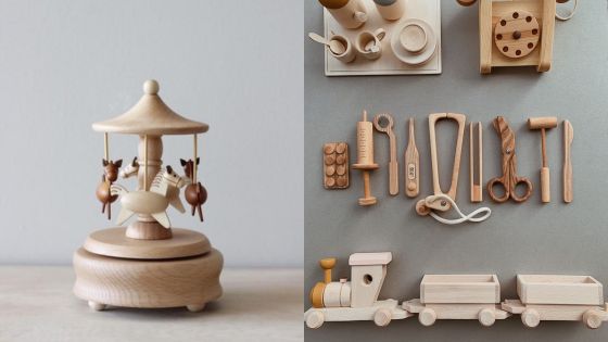 A wooden toy carousel and other wooden toys.
