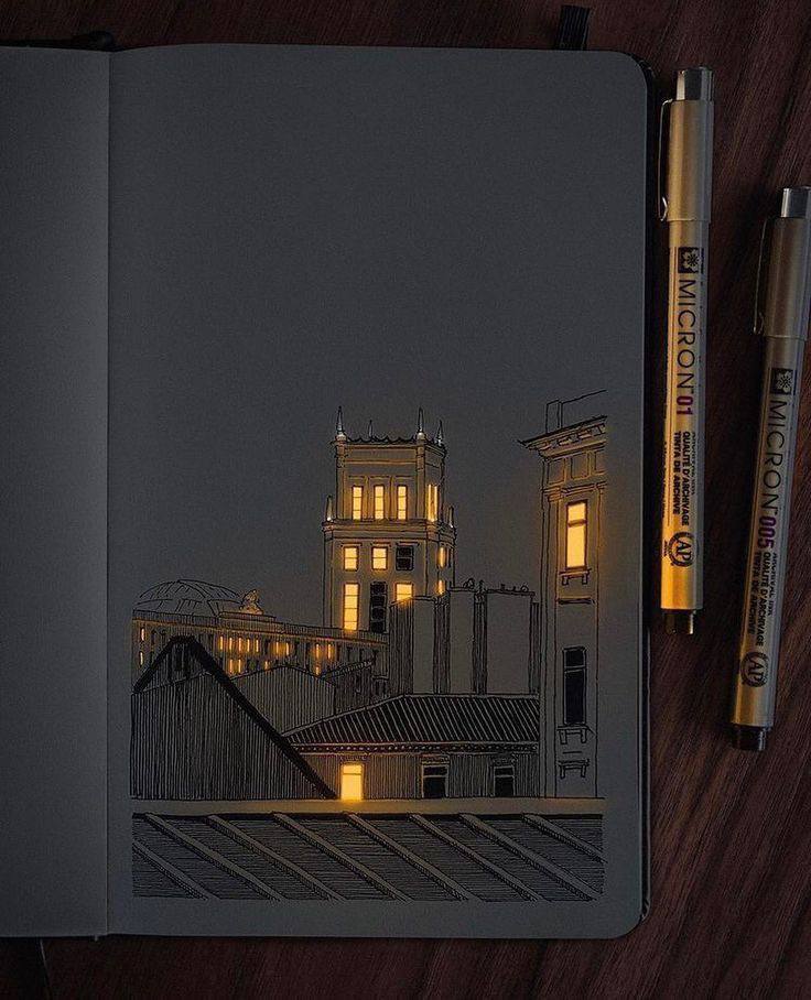a drawing of a city with lights on a book