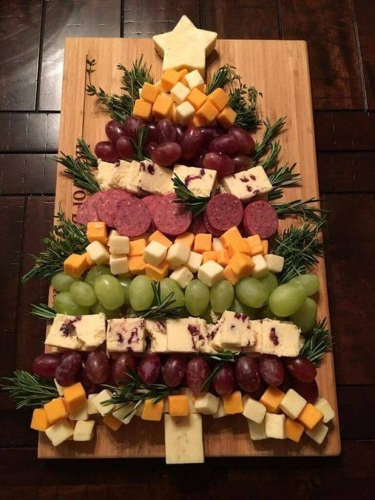 A christmas tree made out of cheese and grapes.