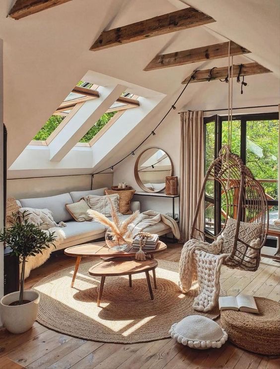 An attic living room with wooden beams and a hammock.