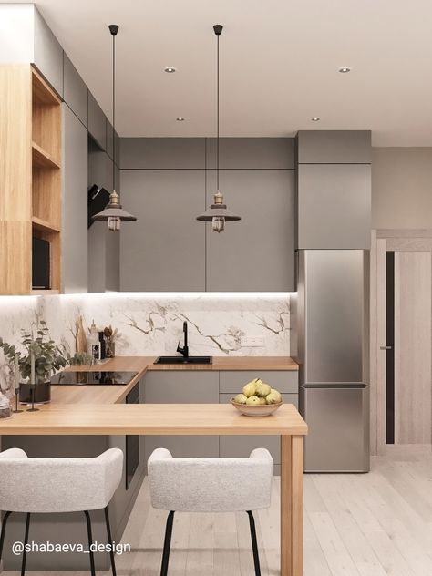 A modern kitchen with grey cabinets and wooden counter tops.