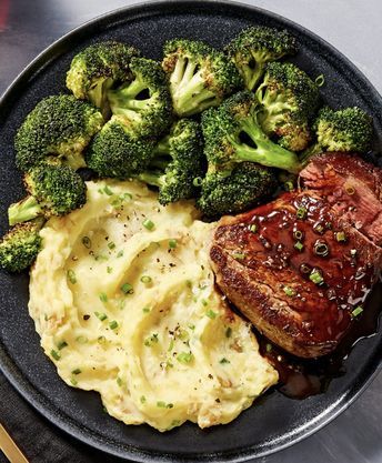 A plate with steak, broccoli and mashed potatoes.