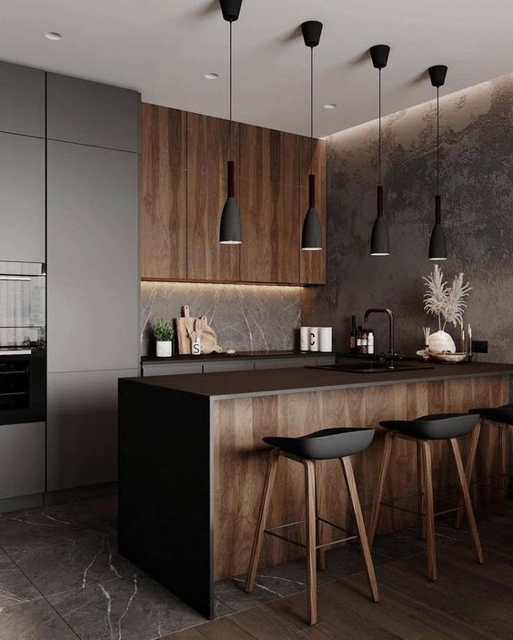 A modern kitchen with wooden cabinets and black counter tops.