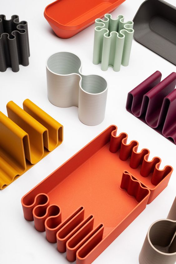 Various modern modular desk organizers in different shapes and colors, neatly arranged on a white surface.