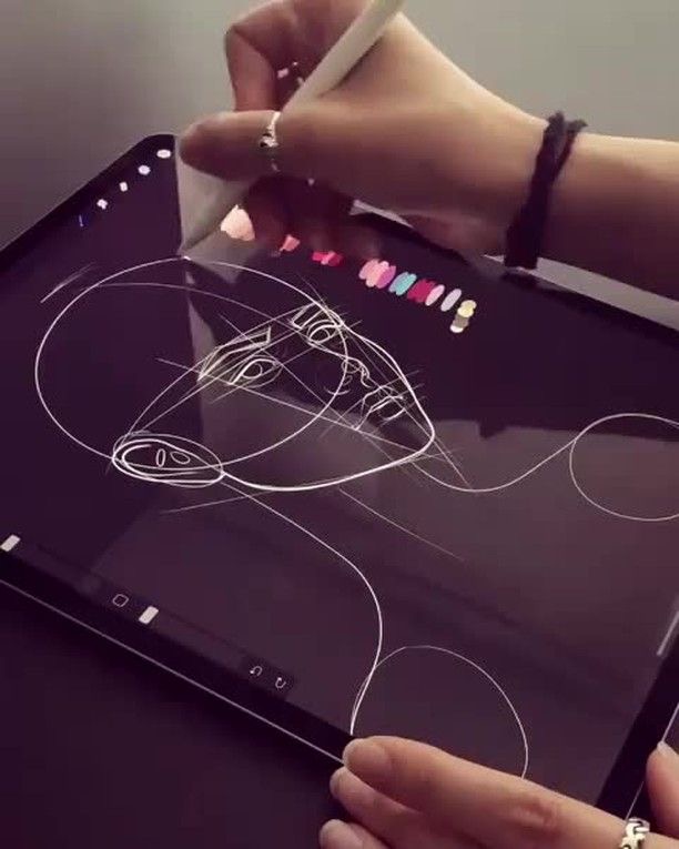 A person uses a stylus to draw a digital sketch of a horse on a tablet screen, displayed alongside a palette of colors.