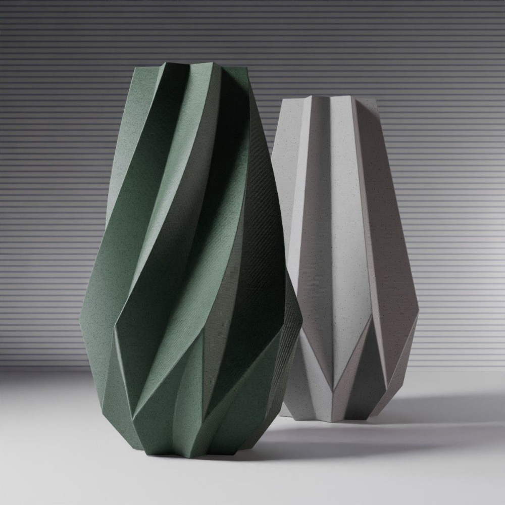 Two geometric vases, one green and one gray, displayed against a striped background.