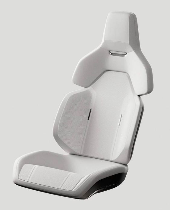 Modern white automotive seat displayed on a light grey background, showcasing its ergonomic design and smooth contours.