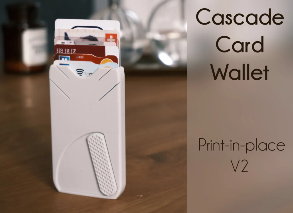 A white card wallet labeled "cascade card wallet" holds multiple credit cards, displayed on a wooden table with blurred kitchenware in the background.