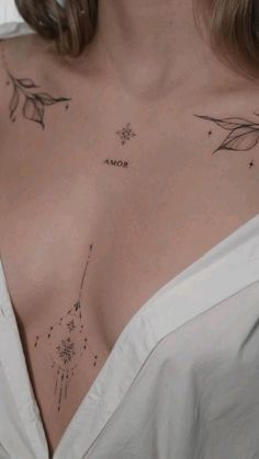 A close-up shows a person wearing a white top, revealing upper chest tattoos of stars, floral patterns, and the word "AMOR.