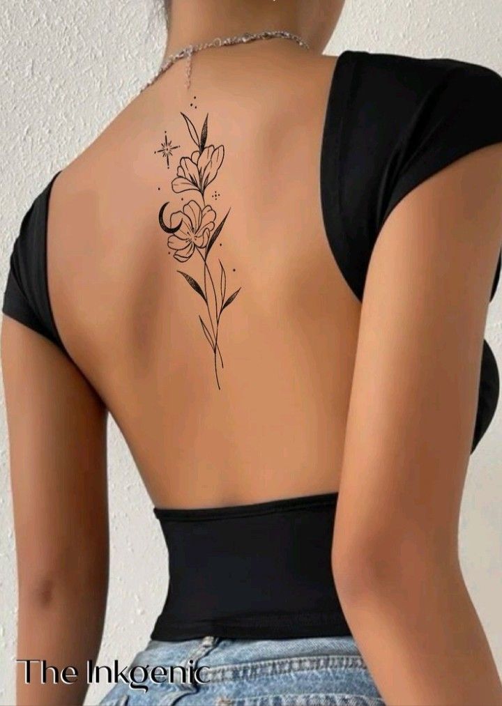 A person in a black, open-back top displays a floral tattoo on their upper back.