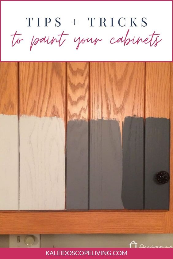 Wooden cabinet doors with partially painted test swatches in various shades of gray and black, under the caption "Tips + Tricks to paint your cabinets.