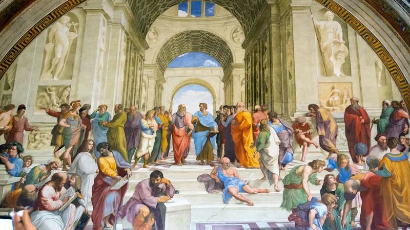 A detailed fresco depicts a gathering of ancient philosophers and scholars in a grand architectural setting with arches and statues, engaging in discussion and contemplation.