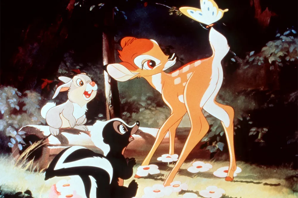 Bambi and friends Thumper the rabbit and Flower the skunk admire a butterfly in the forest in the classic animated film Bambi.
