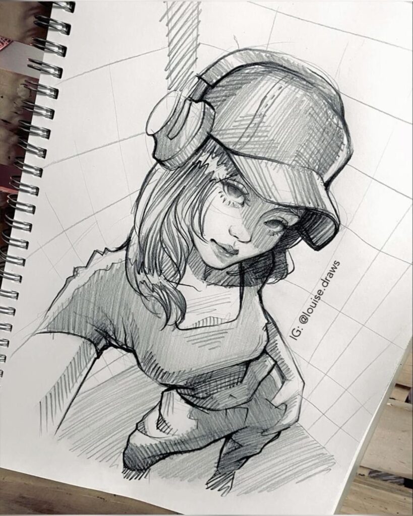 Sketch of a woman wearing a cap and headphones, seen from a high angle. She has long hair and is holding a cloth or similar object. The drawing is in a spiral-bound sketchbook.
