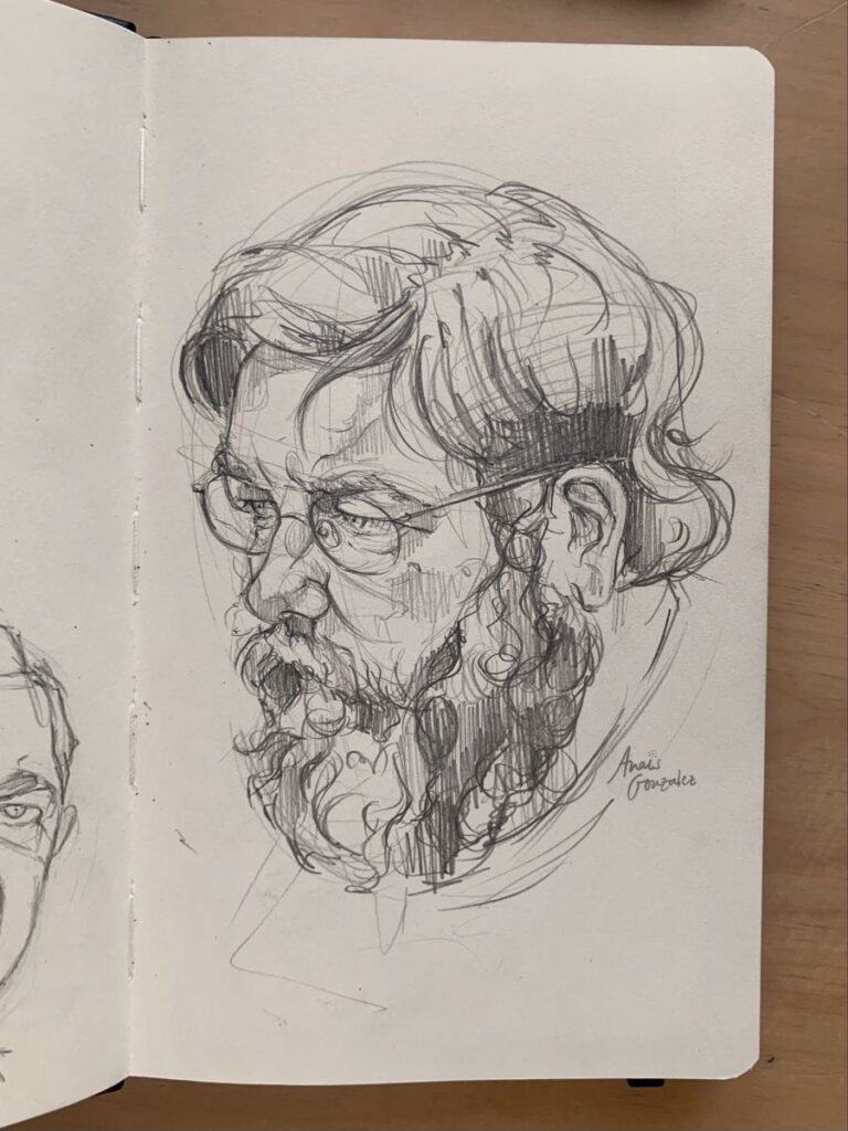 Detailed sketch of a bearded man with glasses in a notebook.