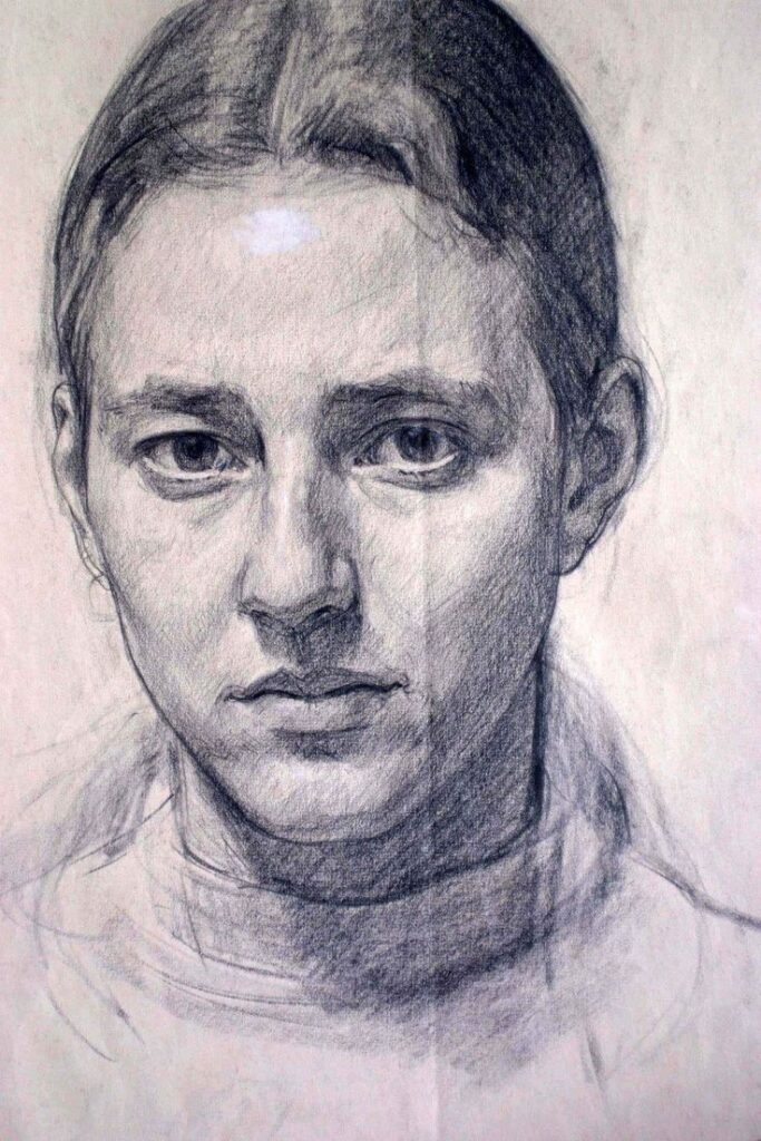 Charcoal sketch of a young person's solemn face with neutral expression.