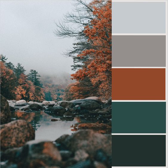 A serene autumn river scene with vibrant orange foliage, rocky banks, and a color palette featuring blues, greys, and greens.