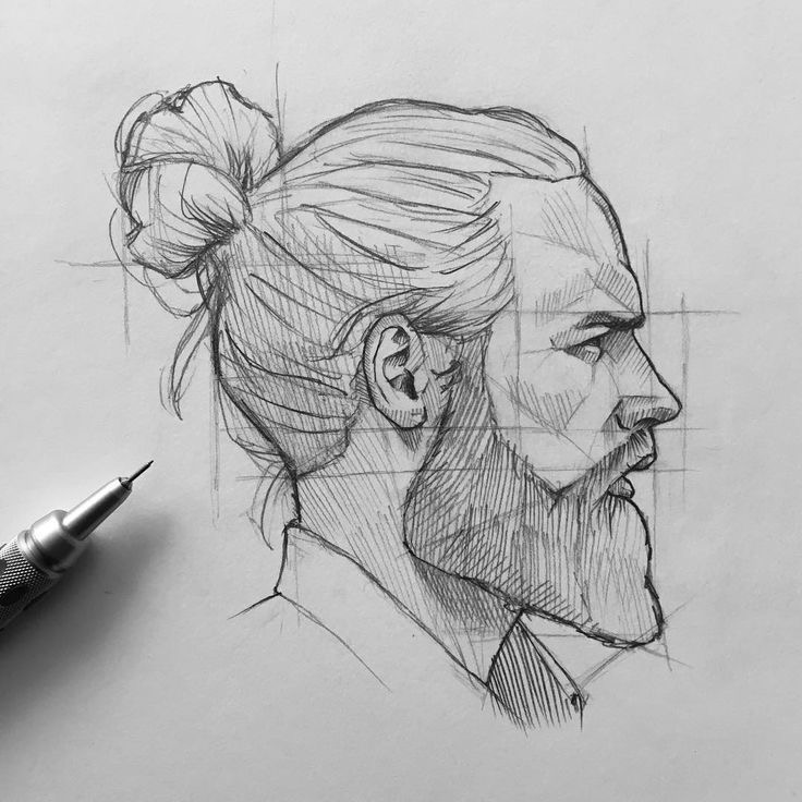 Pencil sketch of a man with a bun, beard, side profile view, on sketchpad with pencil.