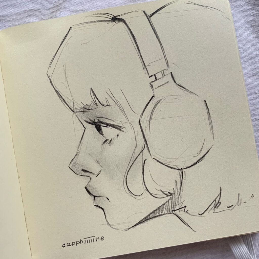 A pencil sketch of a person in profile wearing large over-ear headphones. The sketch focuses on the left side of the person's face.