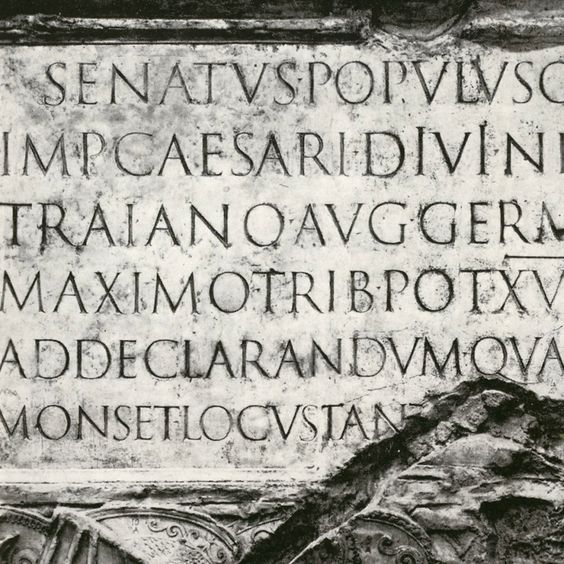 Ancient Roman inscription on a stone monument, displaying Latin text with worn edges, depicting historical significance.