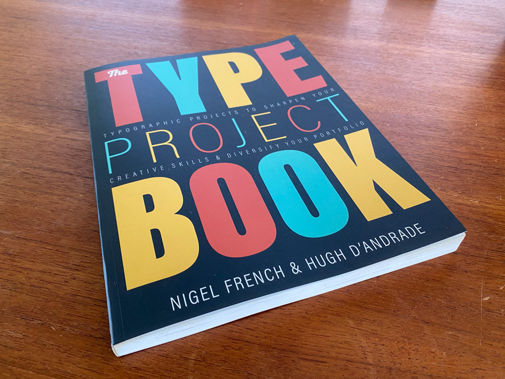 The Type Project Book by Nigel French and Hugh D'Andrade sitting on a wooden surface.