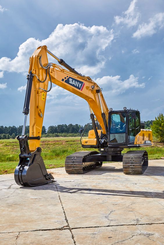 Yellow SANY excavator on a construction site with a blue sky background. Heavy machinery for digging and earthmoving projects.