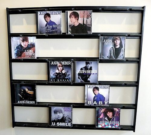 CD rack showcasing various Justin Bieber album covers including Never Say Never and My World 2.0 arranged neatly.