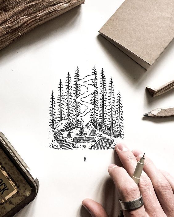 Minimalist camping illustration with a mountain landscape, drawn on paper with pencils and a hand holding a pen in the foreground.