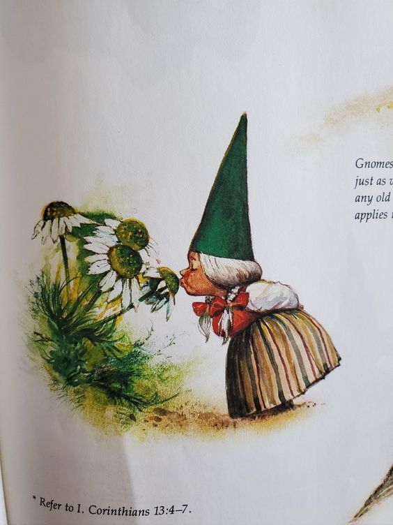 Illustration of a gnome in a green hat and striped skirt smelling daisies, with Refer to 1. Corinthians 13:4-7 text.
