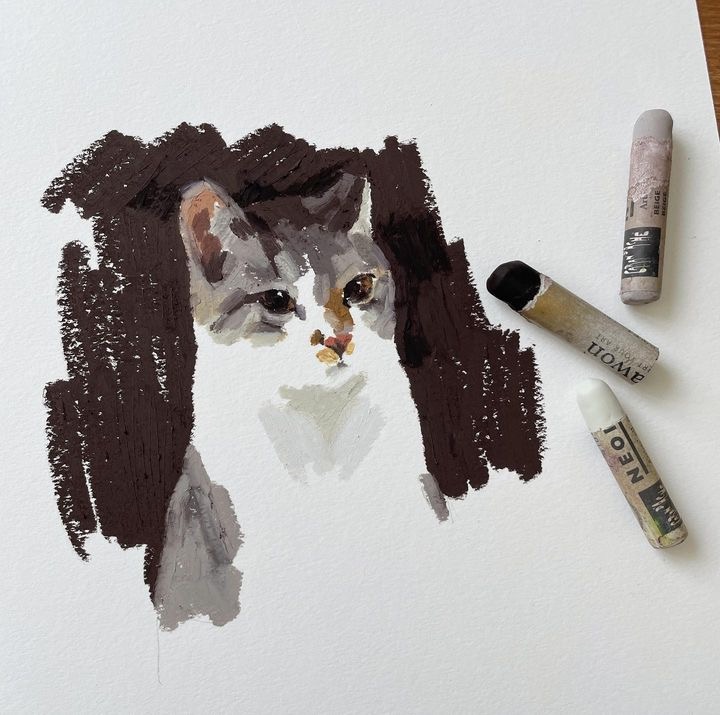 Pastel drawing of a cat with three pastel sticks on paper. Natural cat illustration emphasizing texture and detail.