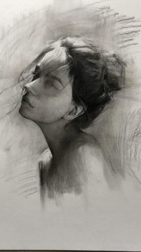 Charcoal sketch of a woman's face with closed eyes and messy hair, capturing a serene, contemplative expression.