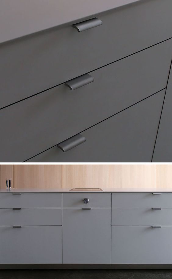 Modern gray kitchen cabinets with sleek metal handles, featuring clean lines and a minimalist design for contemporary kitchens.