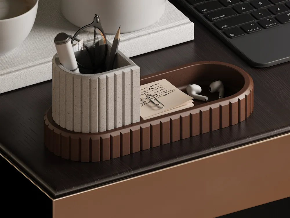 Minimalist desk organizer with pencils, notes, paperclips, and earbuds on a dark wooden desk near a keyboard.