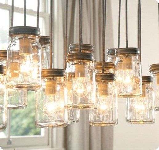 Rustic chandelier made of mason jars with glowing bulbs, enhancing cozy, vintage home decor in a well-lit room.