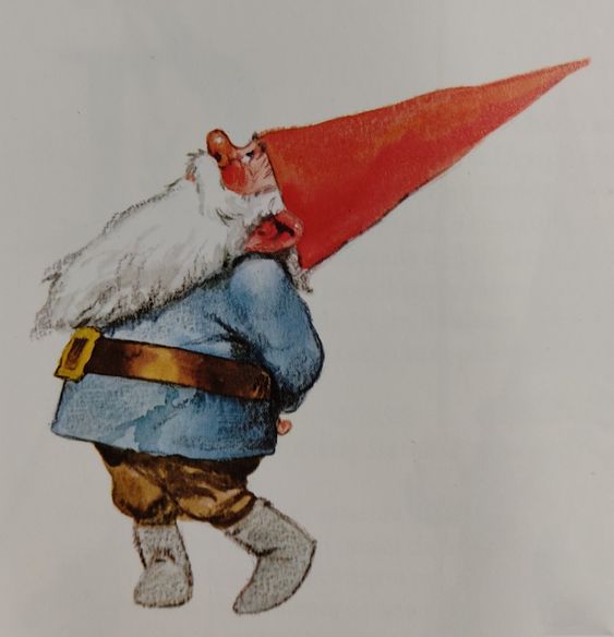 Cute gnome with red hat, long white beard, blue shirt, brown belt, brown pants, and grey boots looking up.