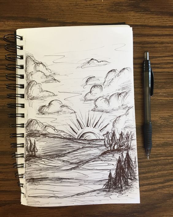 Pen sketch of a scenic landscape with mountains, trees, clouds, and the sun rising; black pen on a spiral-bound notebook.