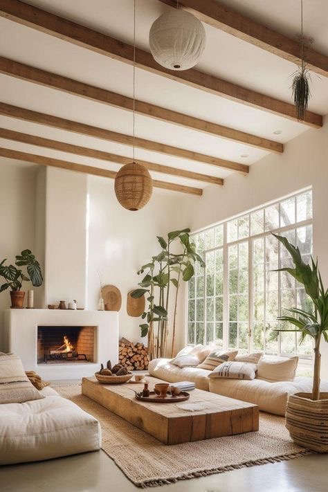 Cozy living room with fireplace, large windows, wooden beams, minimalist decor, and natural lighting. Modern boho interior design.