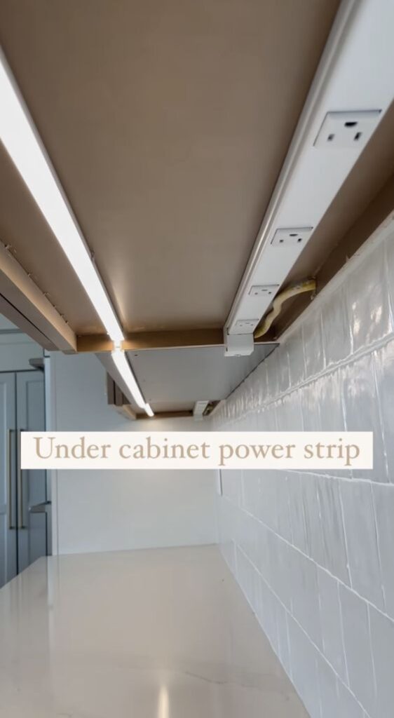 Under cabinet power strip with multiple outlets and LED lighting for a sleek and functional kitchen setup.