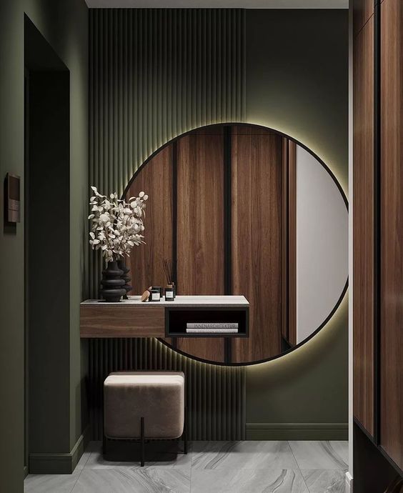 Modern bathroom vanity with round backlit mirror, wooden accents, and black decor in a small, stylish space.